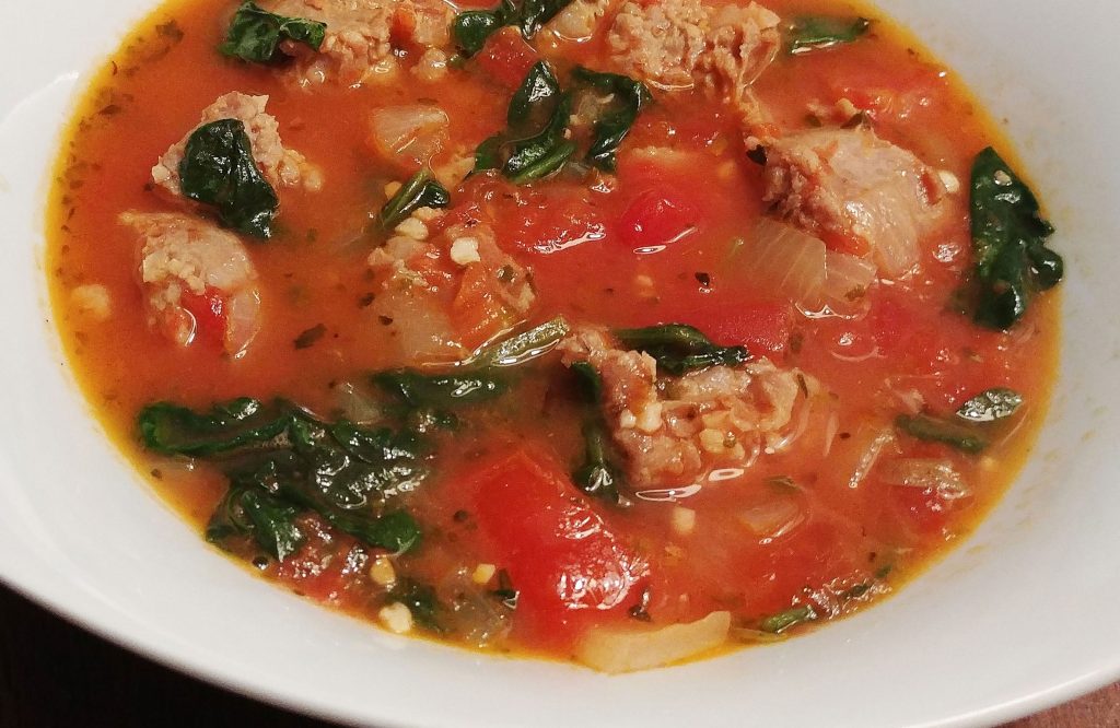 sausage spinach soup in white bowl