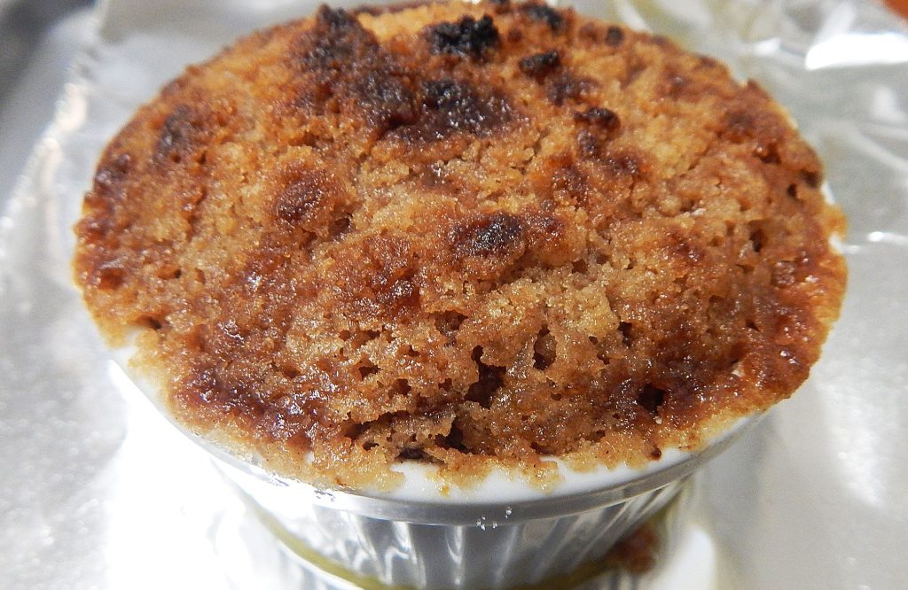 sweet potato crumble in a white ramekin on aluminum foil